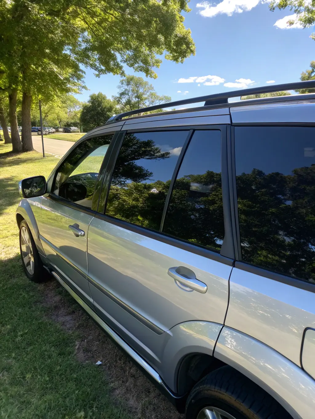A car with professionally installed window tint and a partial wrap, demonstrating the personalized and stylish options available through 303 Detailz's window tinting and wrap services.